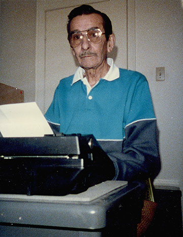 Ron writing his book 'She Won After 9-Year Search'.